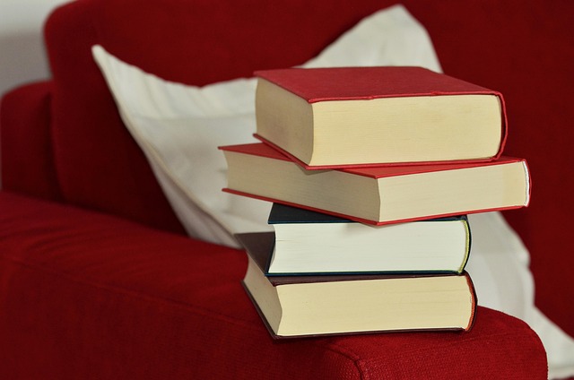 editor reviewing notes beside a stack of books